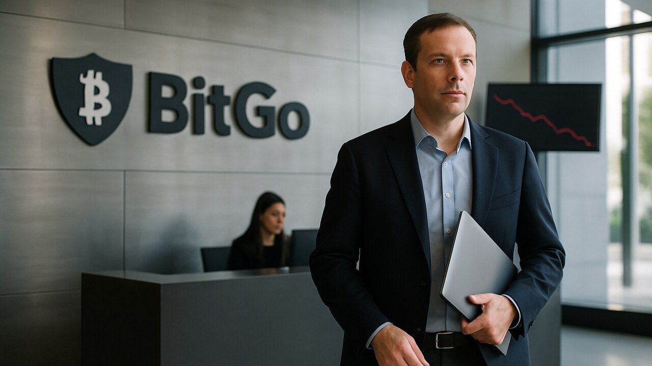 Bedrijfslobby met BitGo-logo op de wand en een medewerker die richting de camera loopt