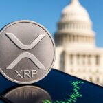 Fysieke XRP-munt op een telefoon met stijgende groene koersgrafiek en het Amerikaanse Capitool op de achtergrond