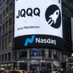 Het gebogen Nasdaq-scherm op Times Square toont JQQQ met de logo's van Stellar en Janus Henderson boven voorbijgangers